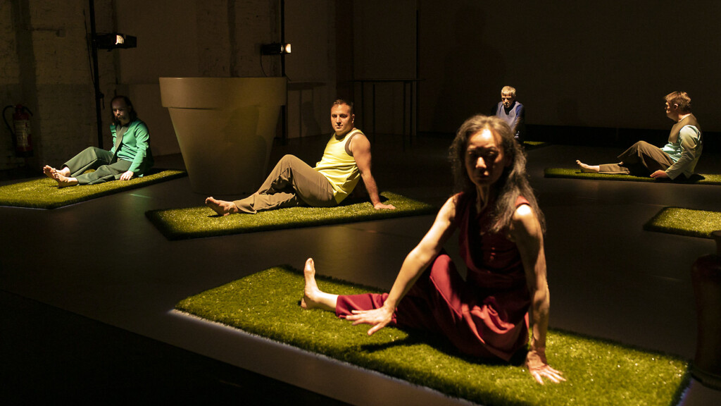 Scene photo of a performance: Five people are sitting on a stage.